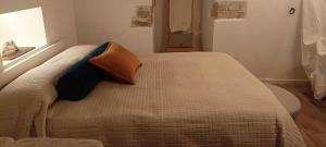 a bedroom with a bed with two pillows on it at Torre del Fornello in Putignano