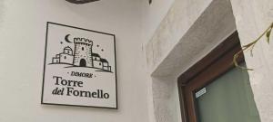 a picture of a sign hanging on a wall at Torre del Fornello in Putignano