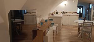 a living room with tables and chairs and a kitchen at Torre del Fornello in Putignano