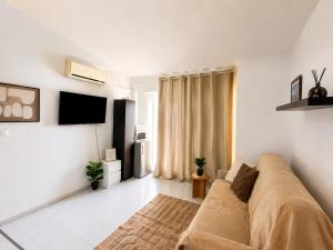 a living room with a couch and a television at Estudio Torreblanca in Torrevieja