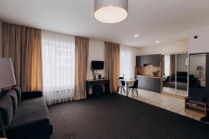 a living room with a couch and a table at Arena Apart - Hotel in Polyana