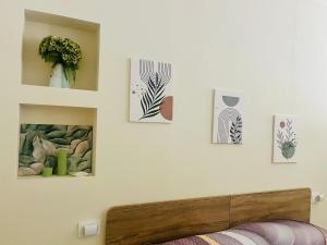 a bedroom with some pictures on the wall at La casetta in Teulada
