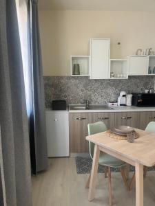 a kitchen with a table and chairs and a counter at La casetta in Teulada +2 photos