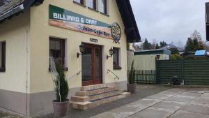 a building with a sign on the side of it at Ferienwohnung Seiffener Hof in Seiffen
