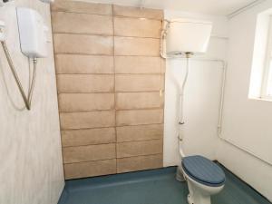 a bathroom with a toilet and a phone at The Watch House in Weymouth +20 photos