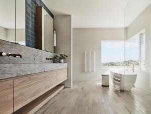 a bathroom with a tub and a large window at Byron Retreat in Coopers Shoot +61 photos