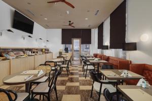 a restaurant with tables and chairs and a bar at Viale in Budva