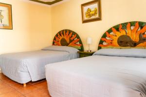 a room with two beds in a room at Malarrimo Restaurant Hotel & RV Parking in Guerrero Negro