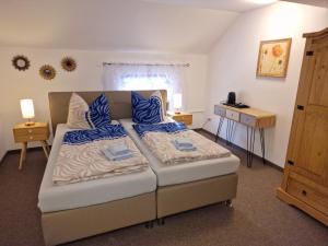 a bedroom with a bed with blue pillows on it at Ferienwohnung Seiffener Hof in Seiffen