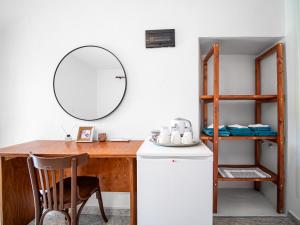 a kitchen with a wooden desk and a mirror at Bodini's Rooms in Himare +99 photos