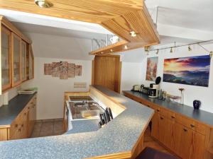 a kitchen with wooden cabinets and a counter top at Ferienwohnung Seiffener Hof in Seiffen