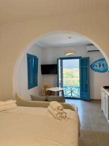 a bedroom with a bed and a window with a view at Apollonia Studios in Katapola