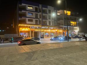 a group of cars driving down a city street at night at Perle de LAtlantique in Kenitra