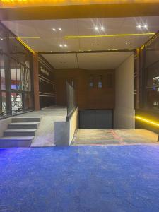an empty gym with blue lights in a building at Perle de LAtlantique in Kenitra