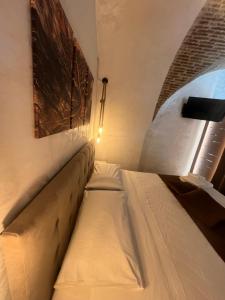 a mattress bed in a room with a window at Mercato29Home in Lucera