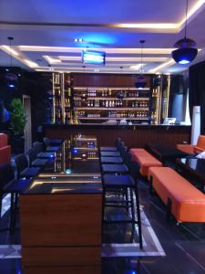 a bar with orange and blue stools in a restaurant at Classy Castle Hotel and Suite in Orho Agbarho