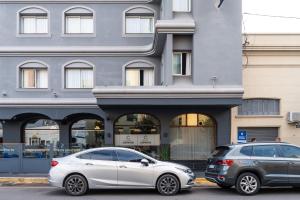 two cars parked in front of a building at Hotel Copahue in Junín