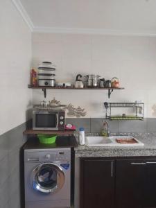a kitchen with a washing machine and a microwave at Villa The View in Tétouan