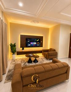 a living room with a couch and a flat screen tv at ChoCho Apartments in Limbe +9 photos