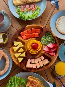 a table topped with plates of food on a table at La Colina Resort SAS in La Vega +65 photos