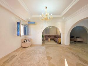 a large living room with a chandelier at Villa Safiya in Djerba +75 photos