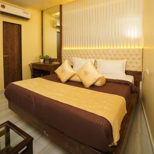 a bedroom with a large bed with two pillows at Hotel Royce By Glitz-Nxt to Visa Consulate & Kurla Station in Mumbai