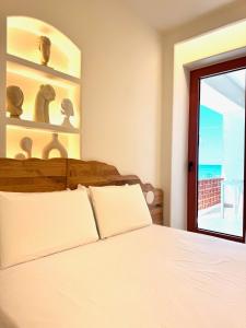 a bedroom with a bed with a view of the ocean at Xanthos Beachfront Suites in Potamiá +12 photos