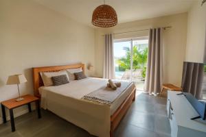 a bedroom with a large bed and a large window at ELOMY VILLA in Albion