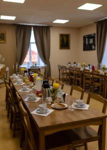 a long wooden table with chairs and plates of food at Spāres muiža in Spāres Muiža