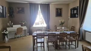 a dining room with a table and chairs and a window at Spāres muiža in Spāres Muiža +21 photos