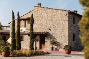 a large stone building with trees in front of it at The Podere Wine Resort Chianti in Barberino di Val dʼElsa +60 photos