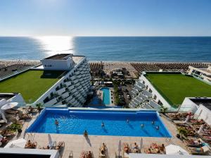 an aerial view of a hotel with a swimming pool and the ocean at INFINITY Sea View Luxury SUITE in Mamaia Sat/Năvodari