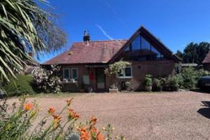 a house with a large driveway in front of it at Sleeps 5 with in picturesque Chiddingly in Lewes