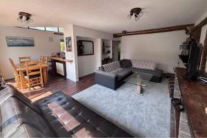 a living room with a couch and a table at Sleeps 5 with in picturesque Chiddingly in Lewes +8 photos