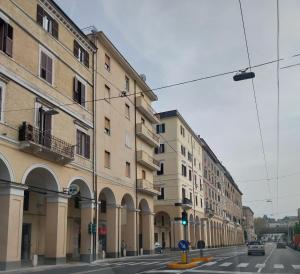a city street with buildings and a green traffic light at VVR6 Rooms by Homes in Ancona in Ancona