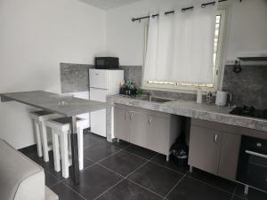 a kitchen with a sink and a counter top at Kelinda in Les Abymes