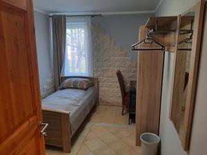 a small bedroom with a bed and a window at Ferienwohnung Lilie in Pegau +6 photos