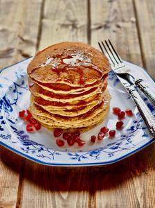 a stack of pancakes on a blue and white plate at Costa Rica explorer in Grecia