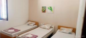 two twin beds in a room with at Bonita in Mostar