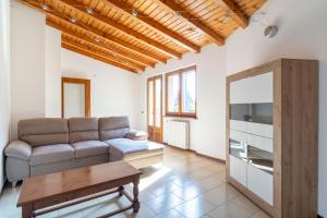 a living room with a couch and a table at Mirafiume - Lugano Lake in Valsolda