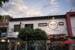a white building with a sign on the side of it at Hotel Riviera Central in Montería