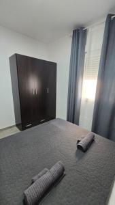 a bedroom with a bed with two pillows on it at Casa NOU in Cullera +11 photos