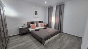 a bedroom with a bed with pink pillows on it at Casa NOU in Cullera