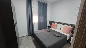 a bedroom with a bed with two stuffed animals on it at Casa NOU in Cullera