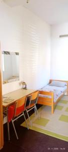 a bedroom with a desk and a bed and chairs at Bonita in Mostar