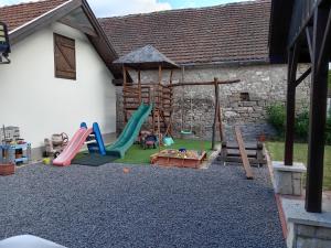 a backyard with a playground with a swing at Cinege Vendégház in Tolcsva