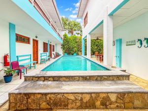 a swimming pool in the backyard of a house at Hotel Gracia in San Juan del Sur
