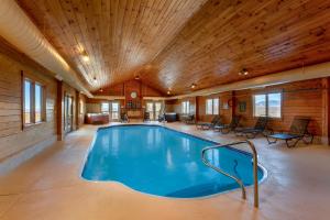 a large indoor swimming pool with a wooden ceiling at Rangeley Lake Resort in Rangeley
