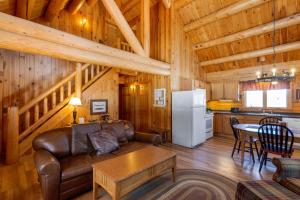 a living room with a couch and a table in a cabin at Rangeley Lake Resort in Rangeley