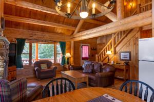 a living room with a kitchen and a dining room at Rangeley Lake Resort in Rangeley